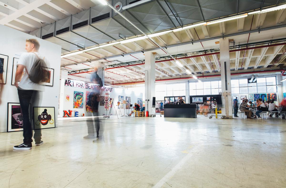 Image of a colorful interactive visual art display with people engaged in creating and touching the art