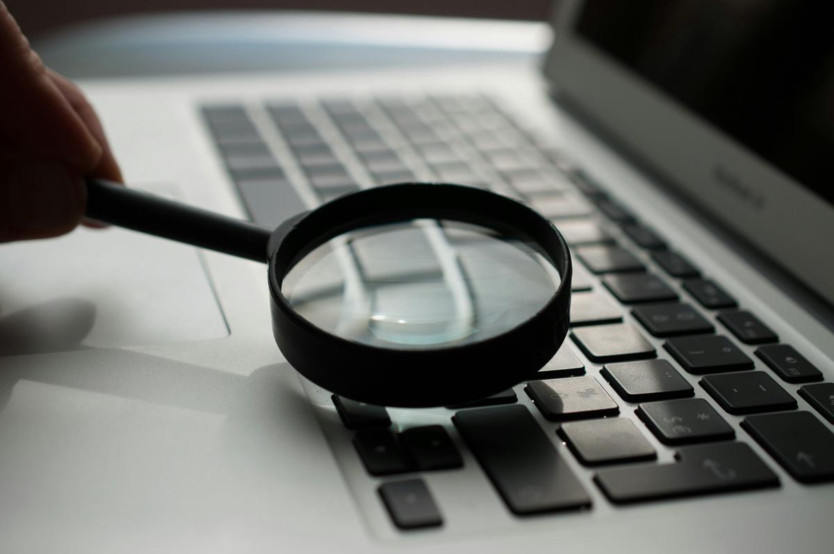 A magnifying glass examining legal documents, symbolizing the importance of quality legal content for website optimization