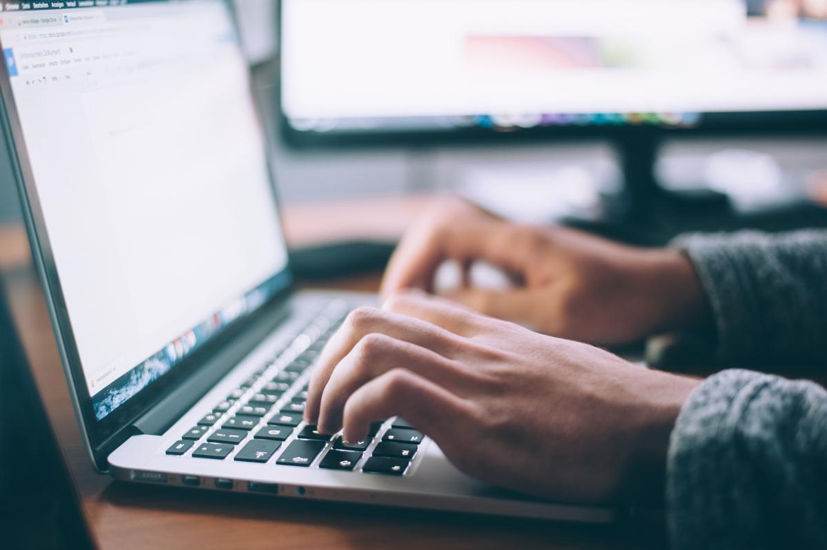 Image depicting a person working on a laptop, representing online data entry jobs.